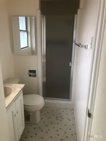 a bathroom with a toilet and a shower
