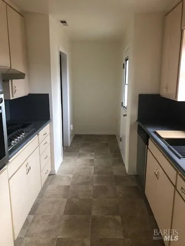 a room with a stove and a refrigerator