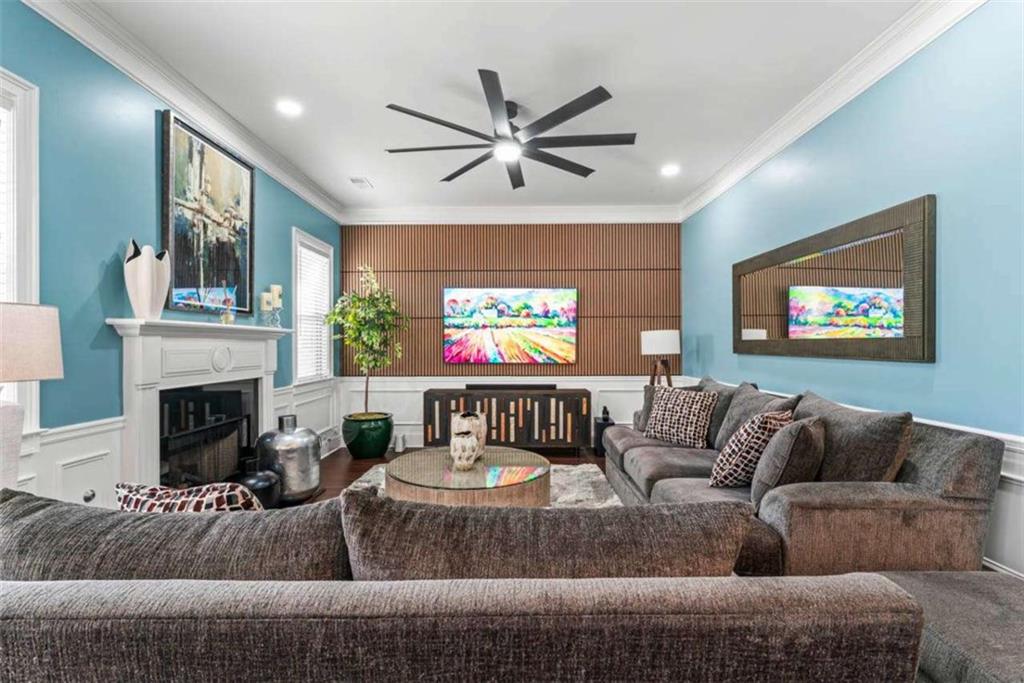 132 Luke Cove Hampton, GA 30228 - Photo 15 of 36 a living room with furniture a fireplace and a flat screen tv