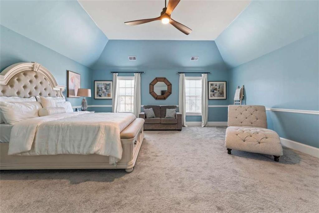 132 Luke Cove Hampton, GA 30228 - Photo 21 of 36 a living room with furniture and a chandelier