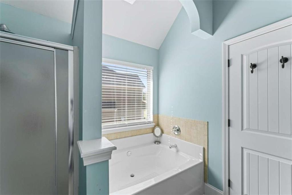 132 Luke Cove Hampton, GA 30228 - Photo 25 of 36 a bathroom with a bathtub and shower