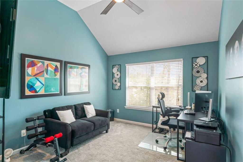 132 Luke Cove Hampton, GA 30228 - Photo 27 of 36 a living room with furniture and a large window