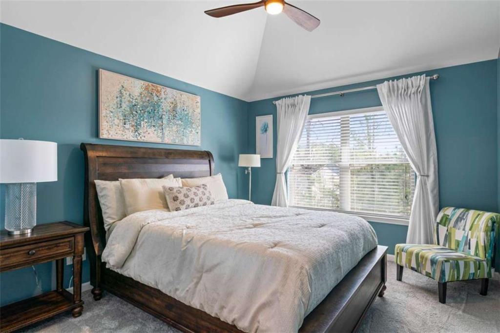 132 Luke Cove Hampton, GA 30228 - Photo 28 of 36 a bedroom with a bed and a window