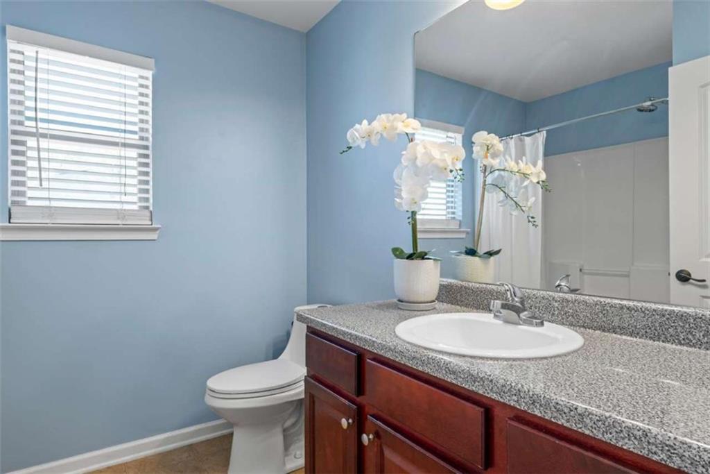 132 Luke Cove Hampton, GA 30228 - Photo 30 of 36 a bathroom with a granite countertop sink toilet and a mirror