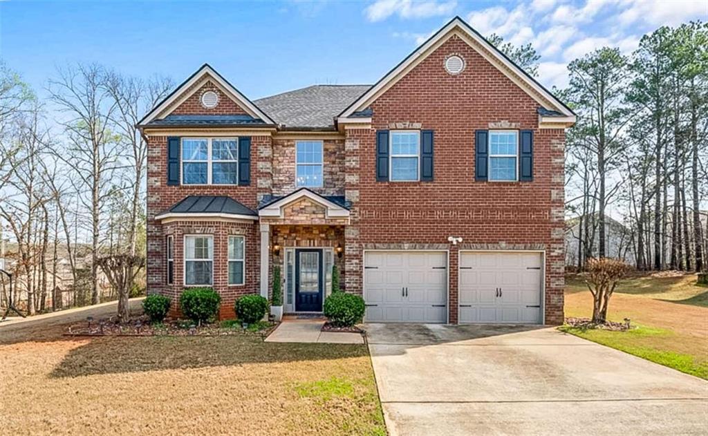132 Luke Cove Hampton, GA 30228 - Photo 5 of 36 a front view of a house with a yard