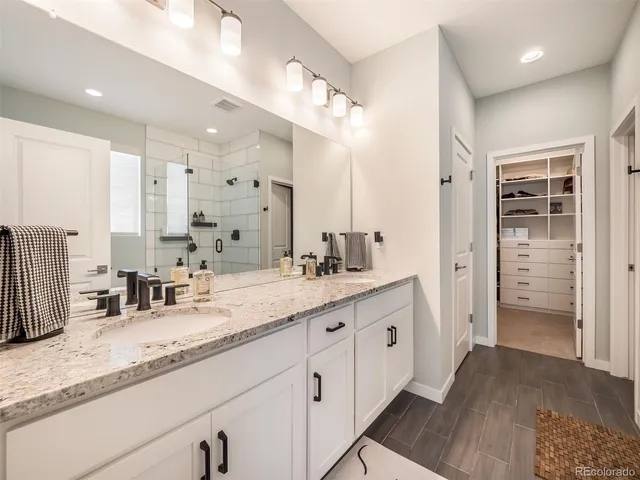 a bathroom with a granite countertop sink mirror and