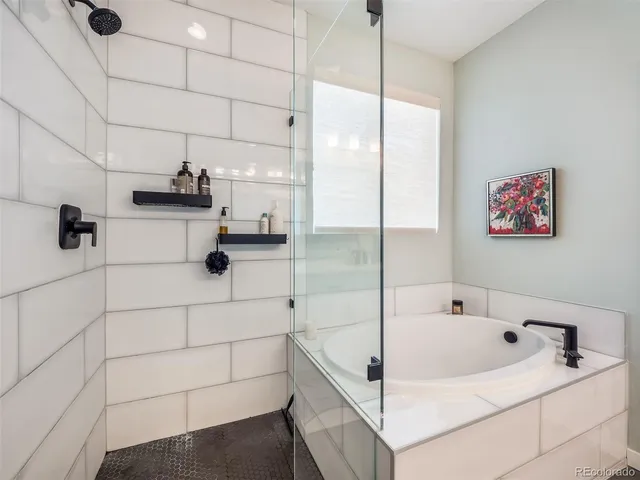 a bathroom with a tub and a shower