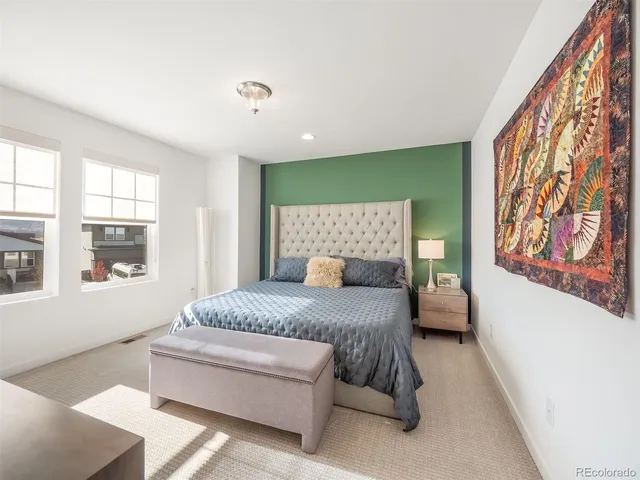 a bedroom with a large bed couch and a window