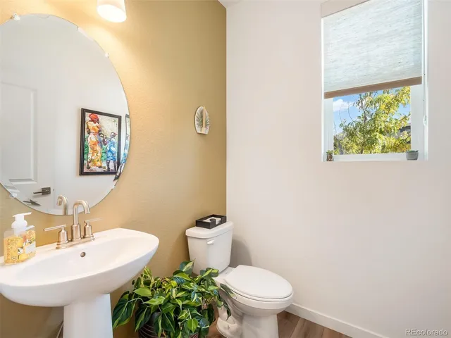 a bathroom with a sink mirror and toilet