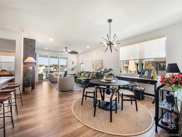 a dining room with furniture a kitchen and chandelier