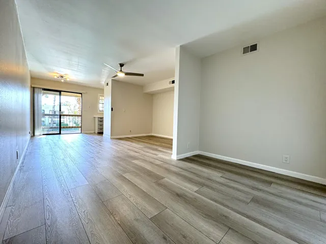wooden floor in an empty room with a window