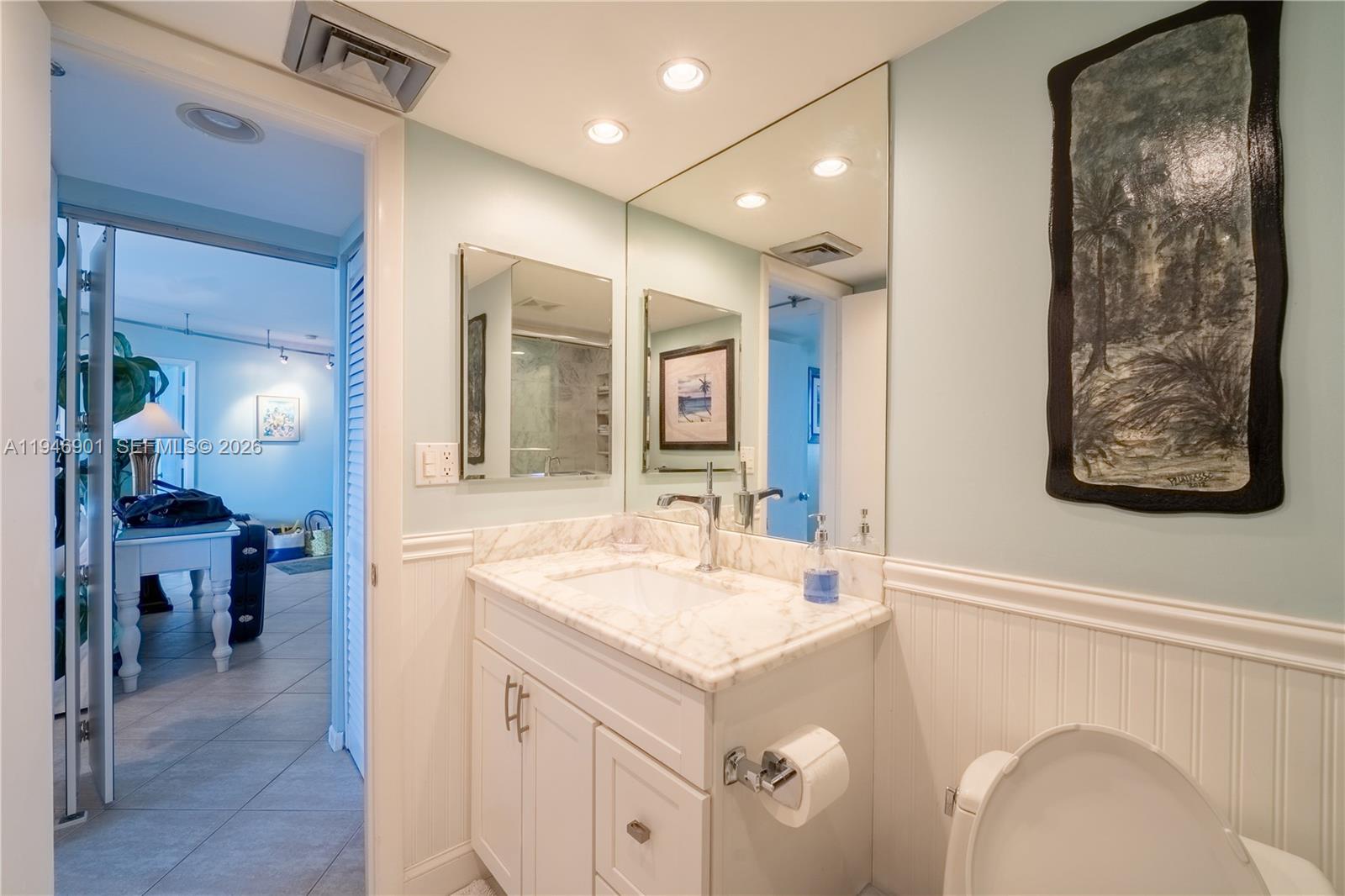 100 Ocean Trail Way, Unit 408 Jupiter, FL 33477 - Photo 18 of 46 a bathroom with a sink and a mirror