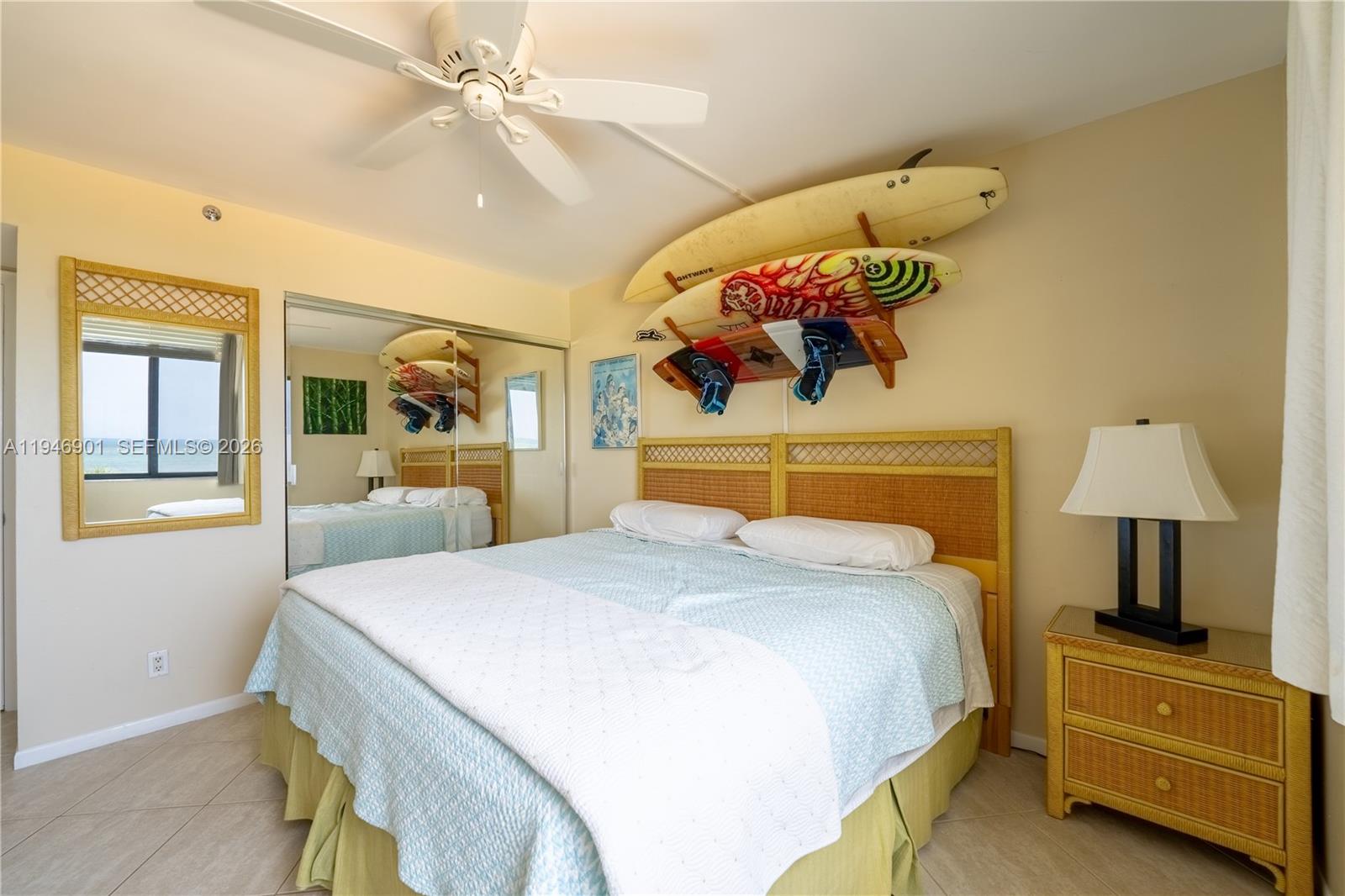 100 Ocean Trail Way, Unit 408 Jupiter, FL 33477 - Photo 22 of 46 a bedroom with a bed and a chandelier
