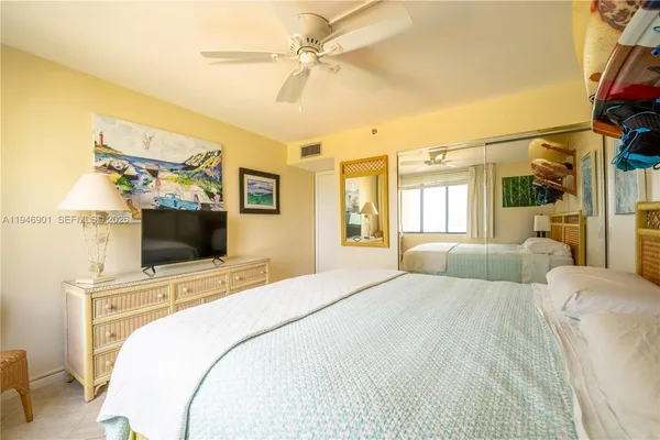 a bedroom with a bed and a flat screen tv