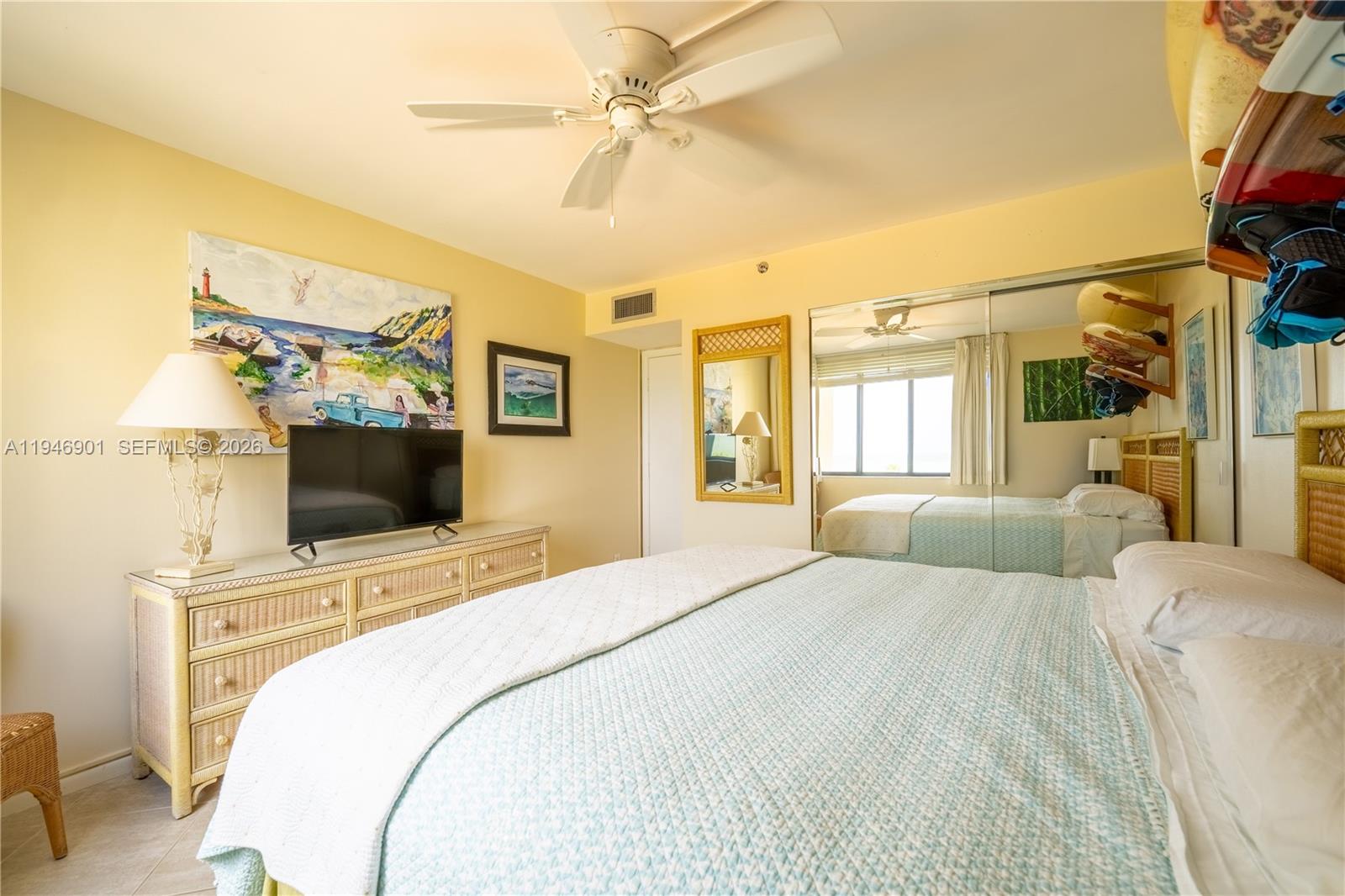 100 Ocean Trail Way, Unit 408 Jupiter, FL 33477 - Photo 23 of 46 a bedroom with a bed and a flat screen tv