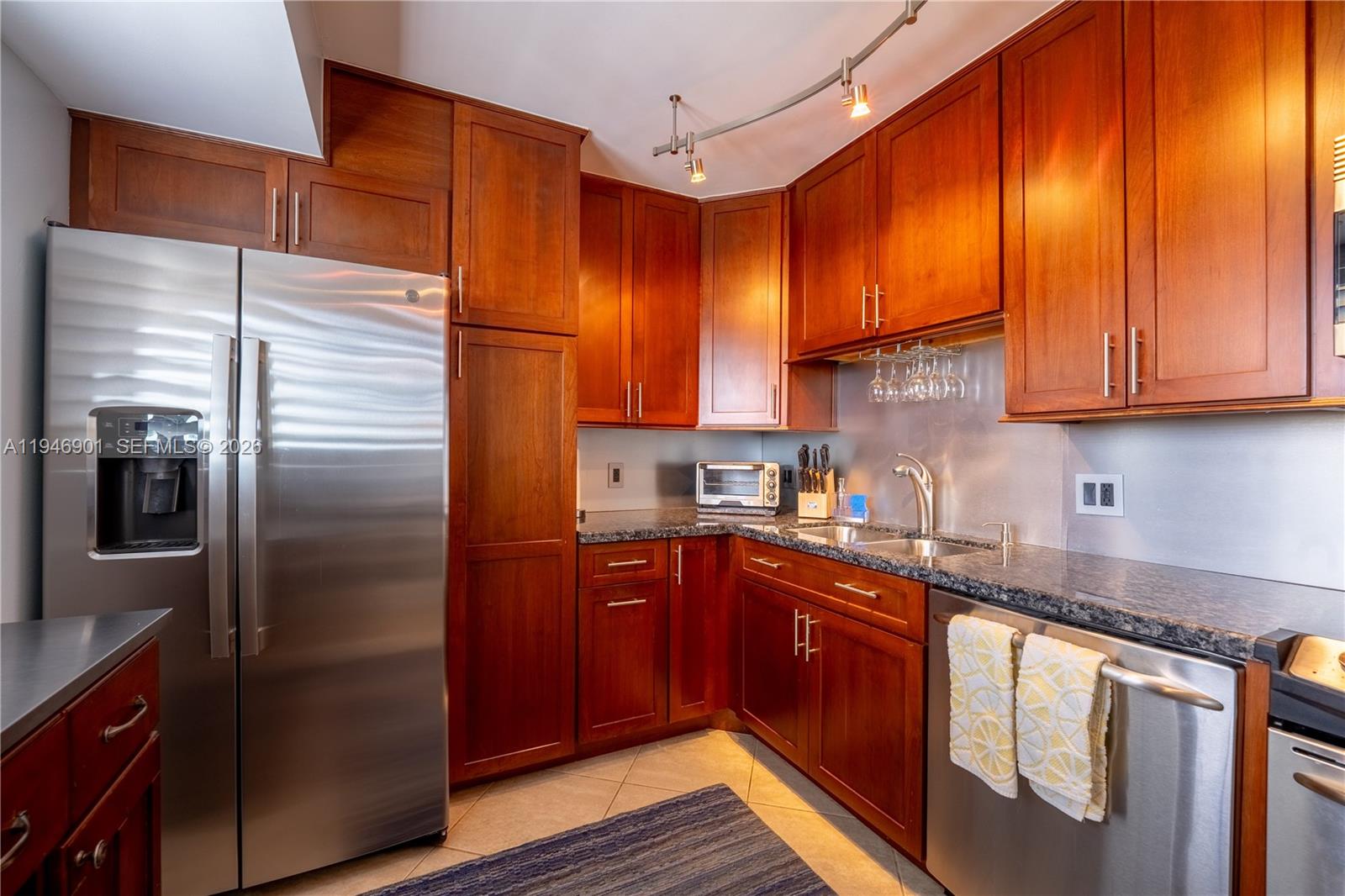 100 Ocean Trail Way, Unit 408 Jupiter, FL 33477 - Photo 28 of 46 a kitchen with stainless steel appliances granite countertop a refrigerator a sink and dishwasher