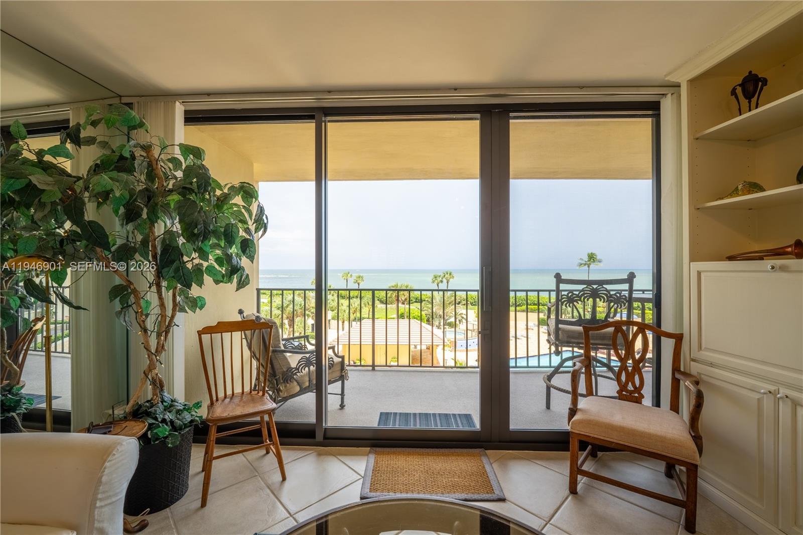 100 Ocean Trail Way, Unit 408 Jupiter, FL 33477 - Photo 38 of 46 a living room with a floor to ceiling window and a table