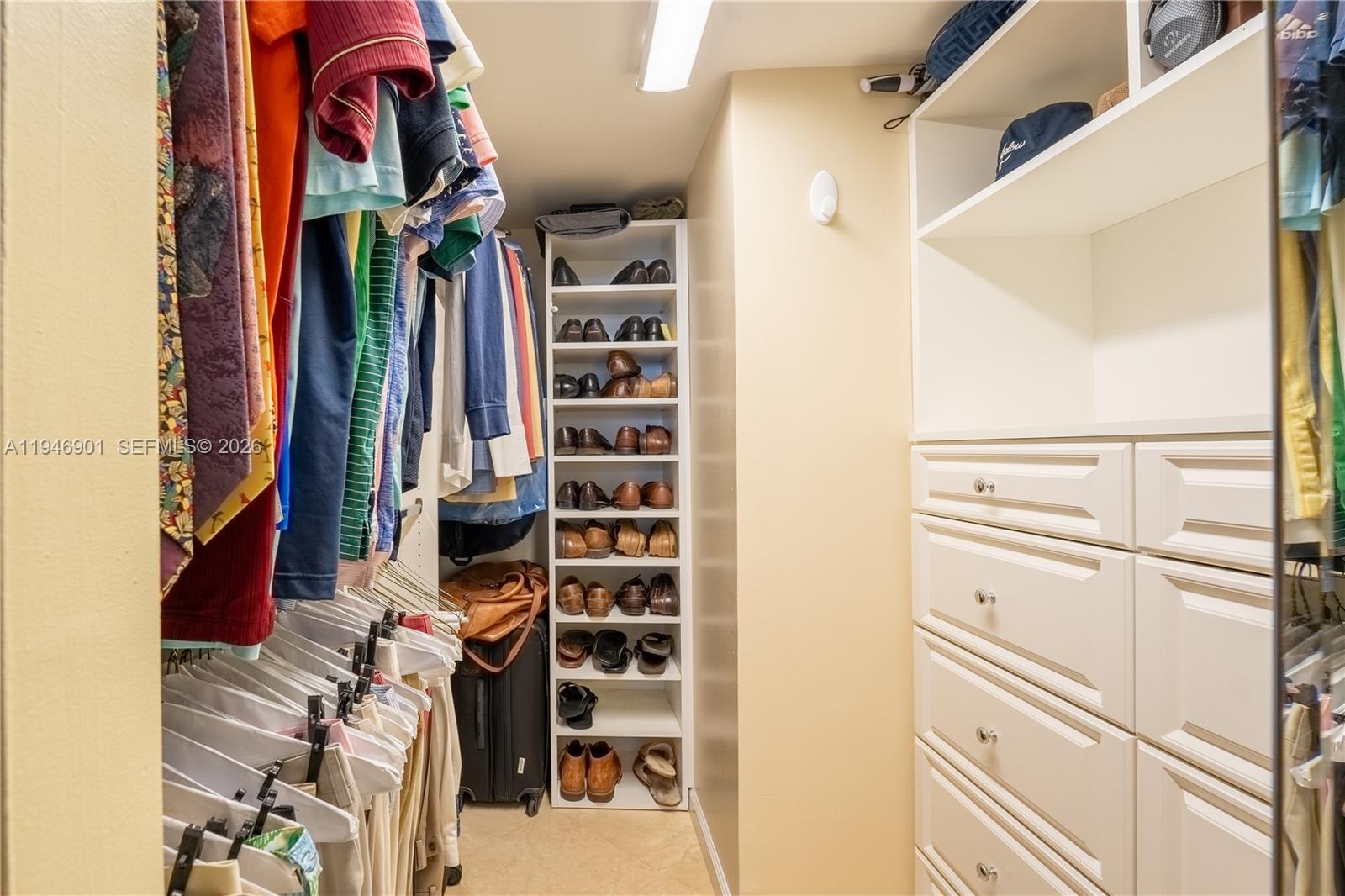 100 Ocean Trail Way, Unit 408 Jupiter, FL 33477 - Photo 9 of 46 a view of walk in closet with clothes and shoes