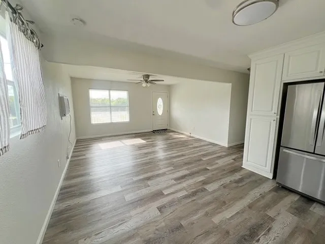 a view of a room with wooden floor and window