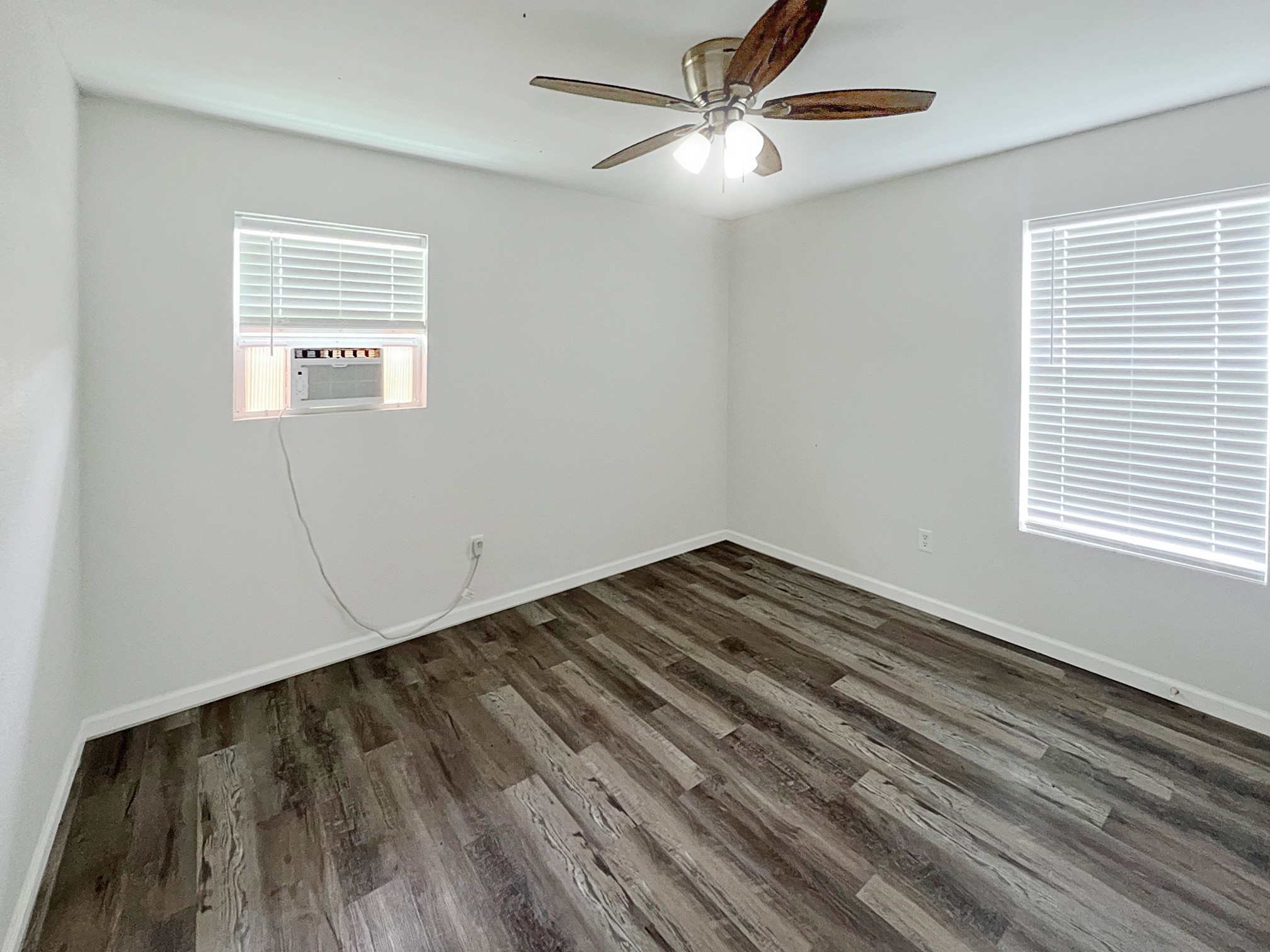 1855 Campbell Road Winnie, TX 77665 - Photo 7 of 11 a view of empty room with wooden floor and fan