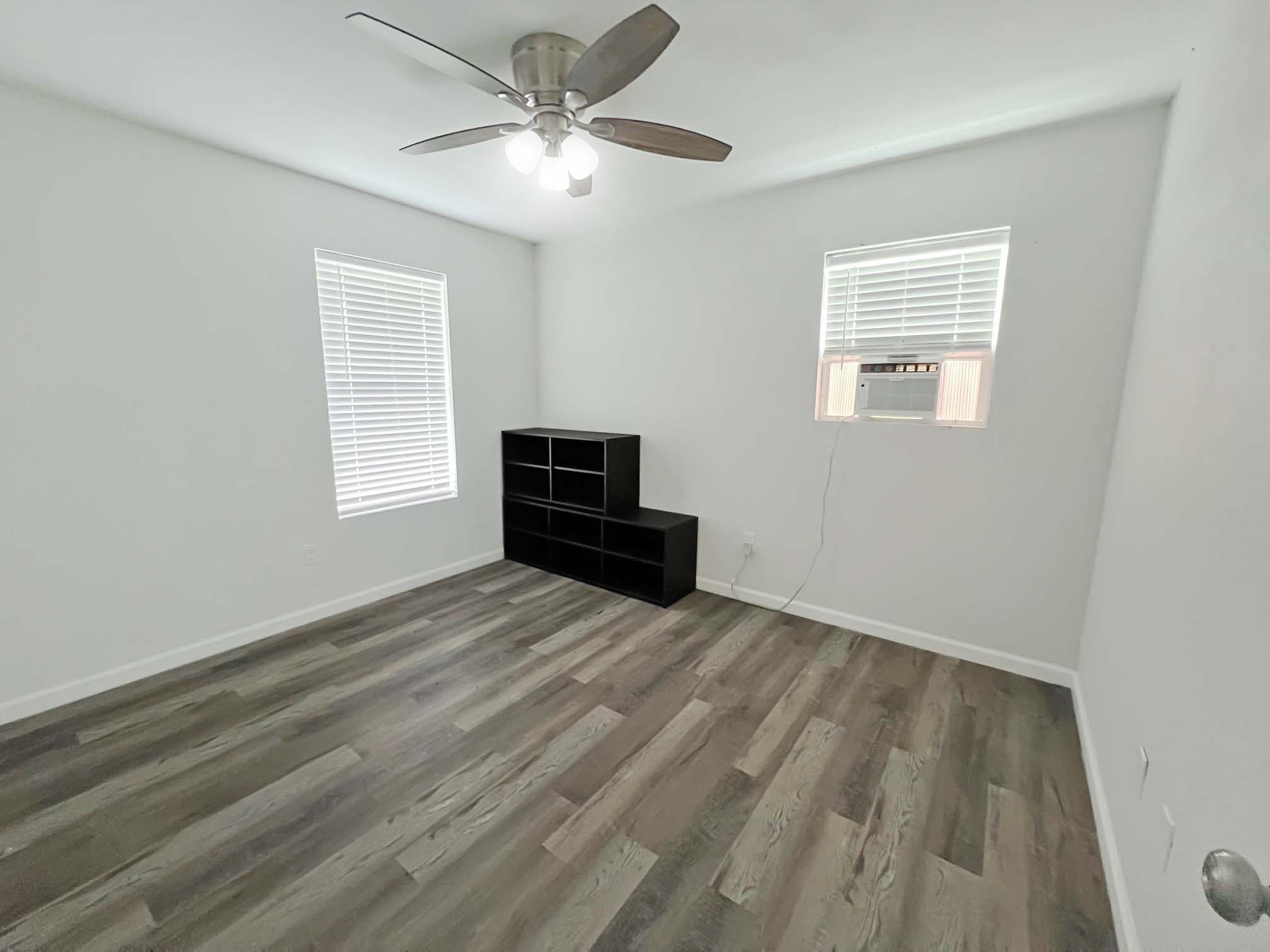 1855 Campbell Road Winnie, TX 77665 - Photo 9 of 11 a view of empty room with wooden floor and fan