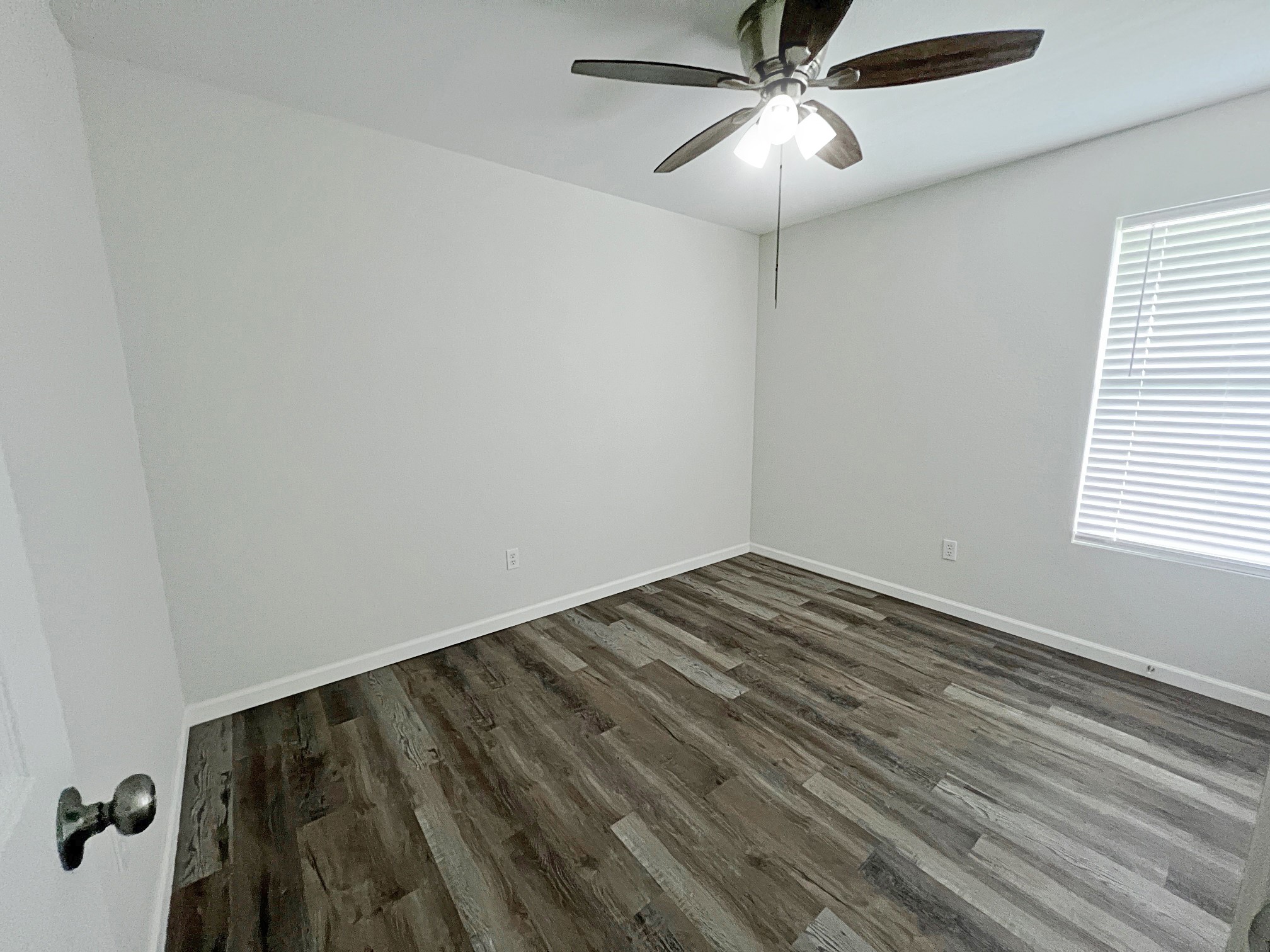 1855 Campbell Road Winnie, TX 77665 - Photo 10 of 11 a view of empty room with wooden floor and fan