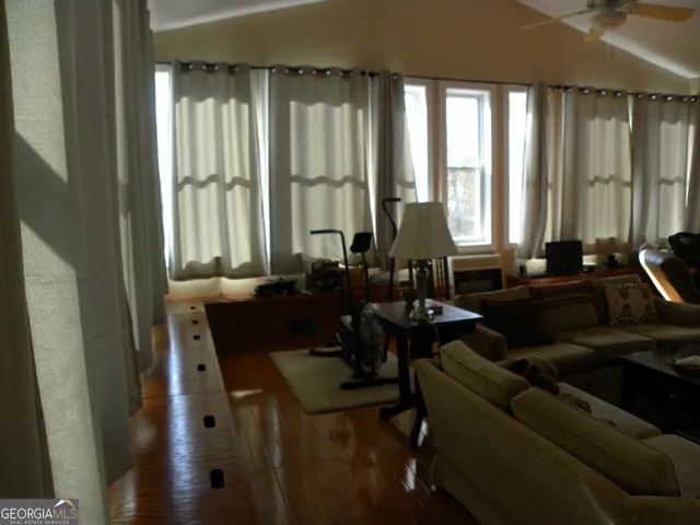 a room with a table chairs and a wooden floor