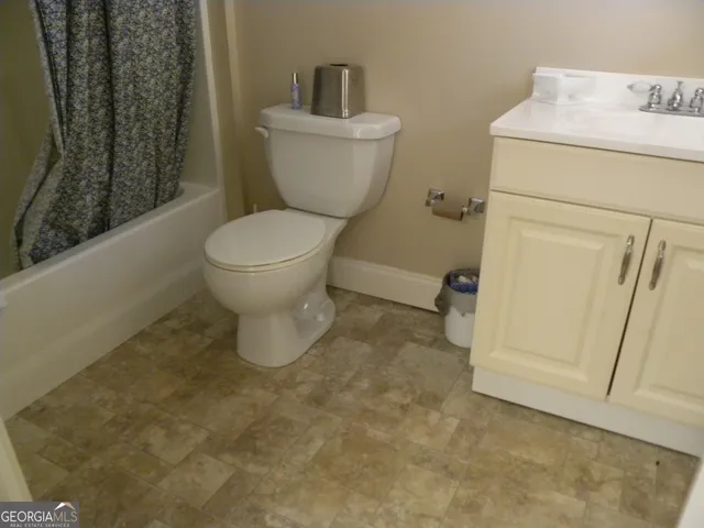 a view of a yard with wooden fence