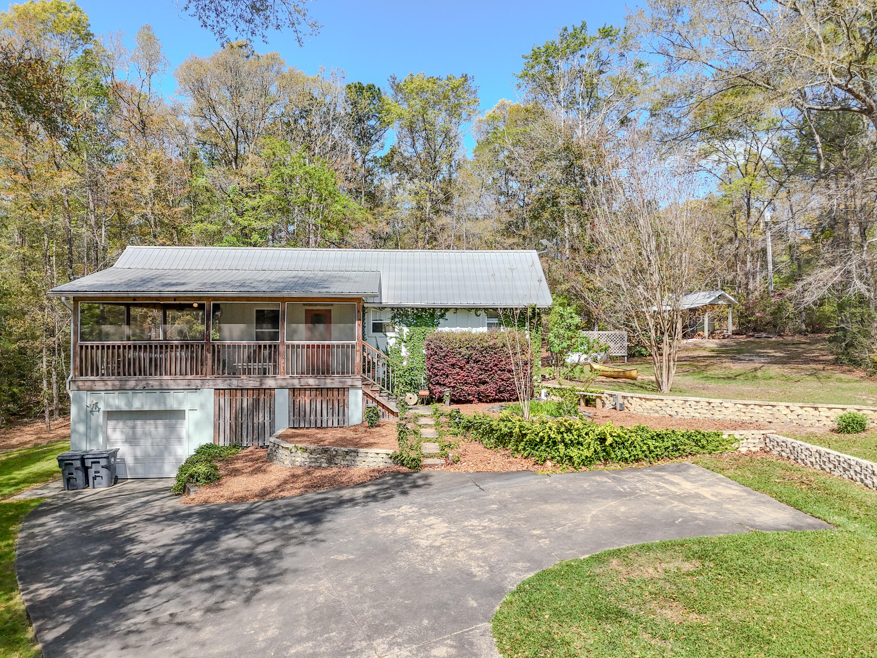211 Lester Price Road Ponce de Leon, FL 32455 - Photo 1 of 63 a front view of a house with a yard and garage