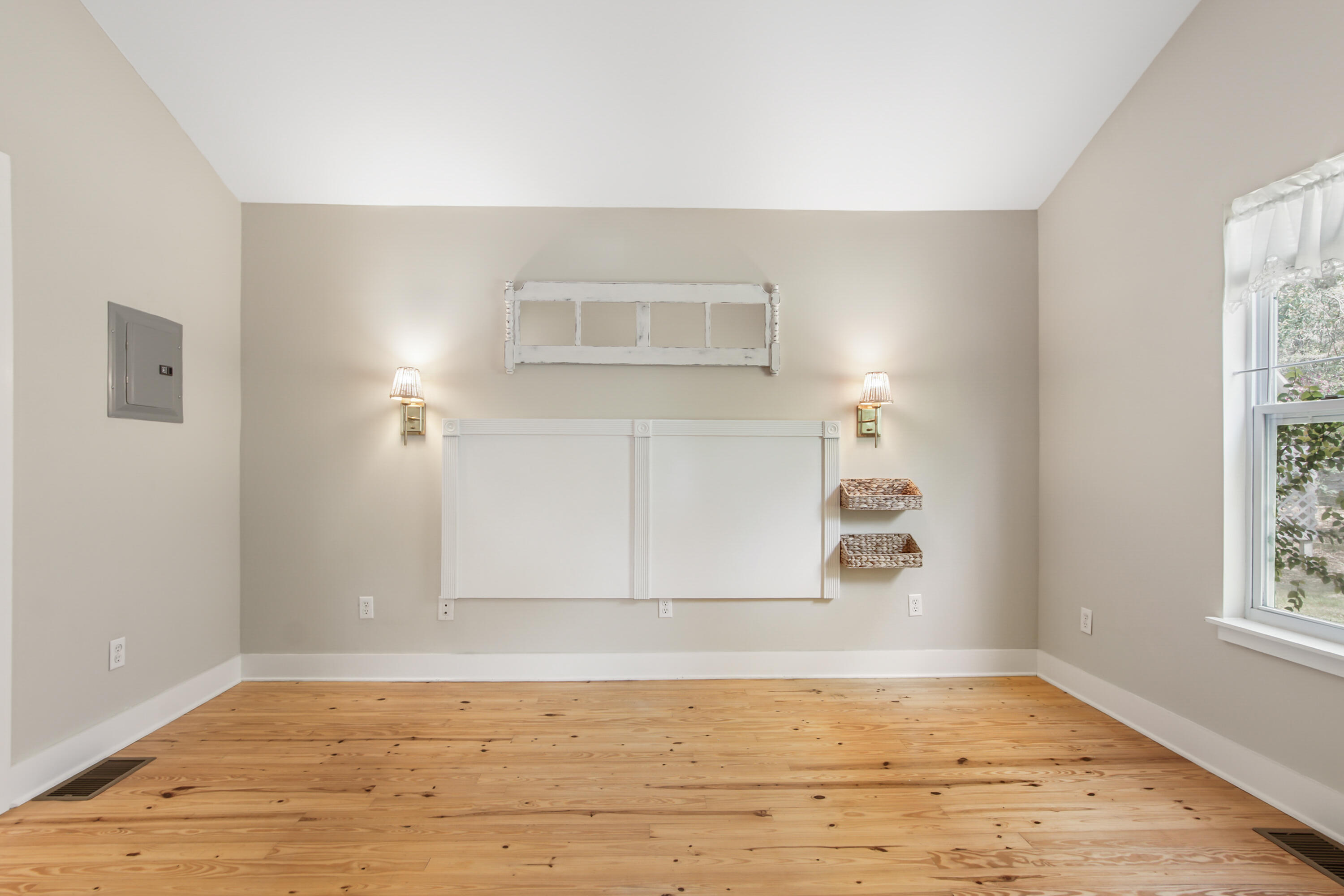 211 Lester Price Road Ponce de Leon, FL 32455 - Photo 19 of 63 a view of an empty room with wooden floor and a window