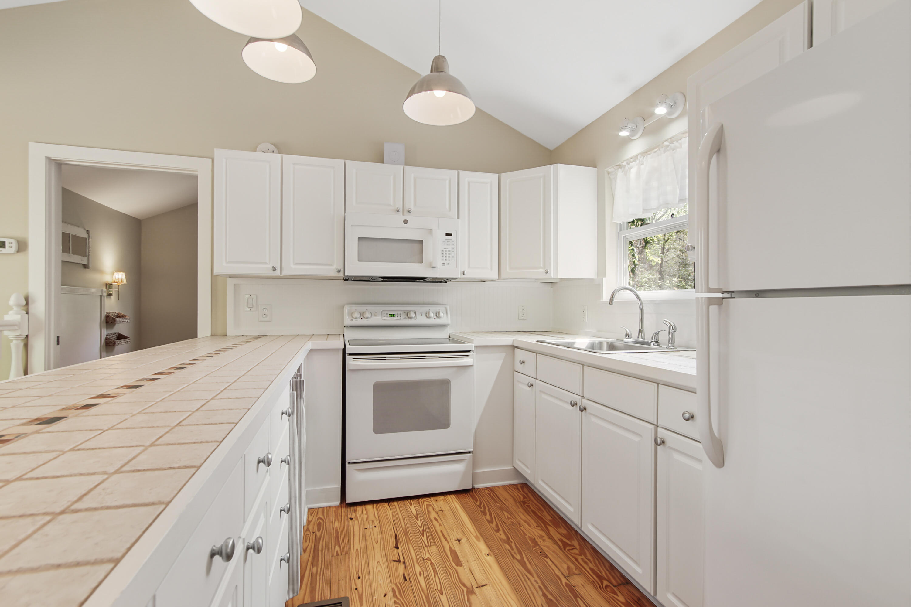 211 Lester Price Road Ponce de Leon, FL 32455 - Photo 6 of 63 a kitchen with a sink stove and white cabinets