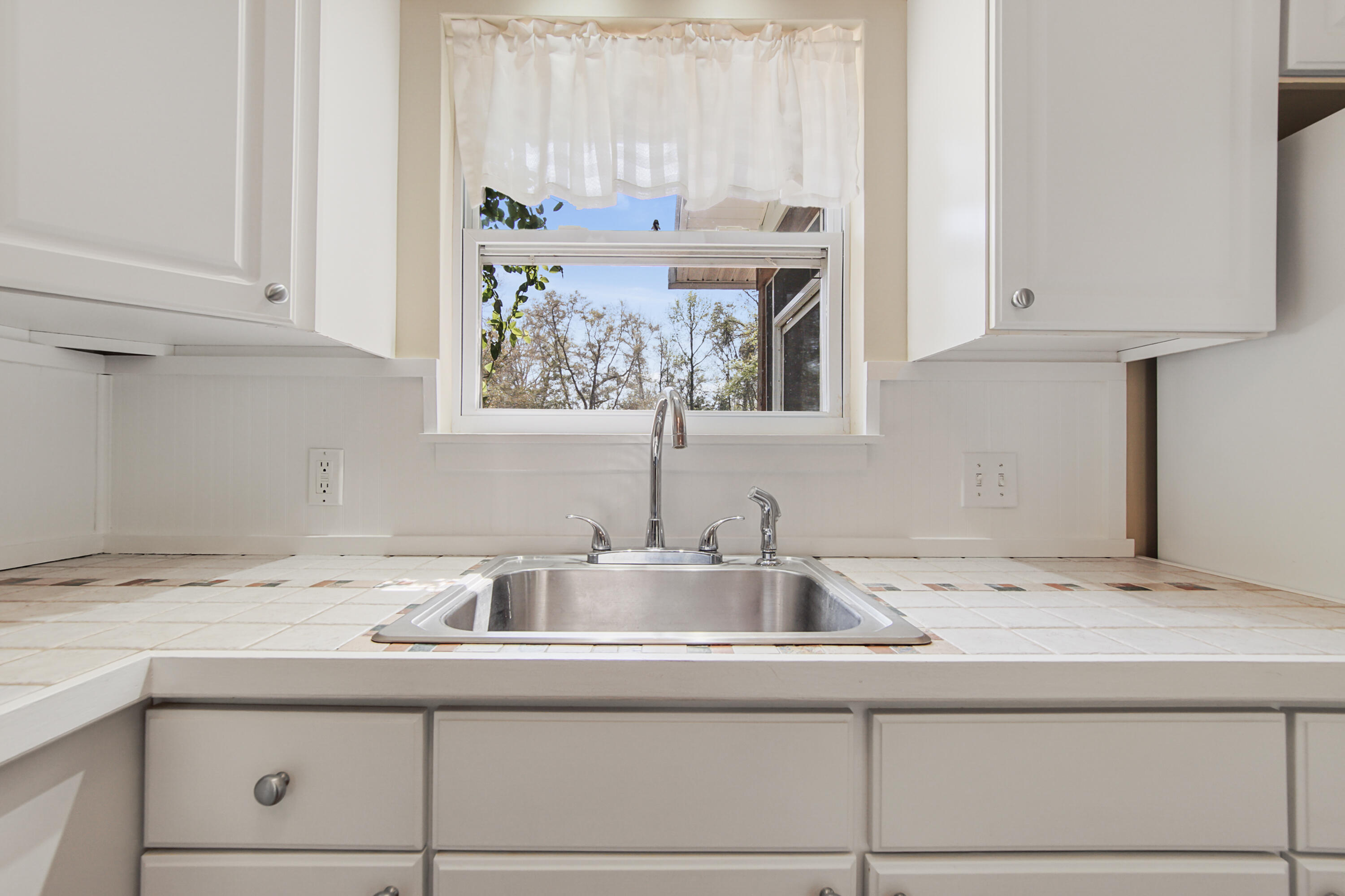 211 Lester Price Road Ponce de Leon, FL 32455 - Photo 7 of 63 a kitchen with a sink and cabinets