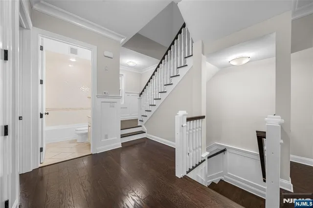 a view of entryway and hall with wooden floor