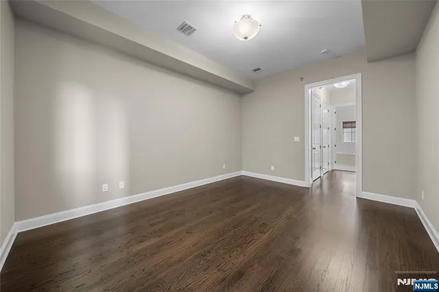 a view of walk in closet with empty racks