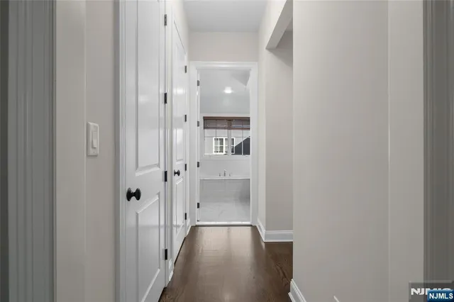 a spacious bathroom with a granite countertop double vanity sink a mirror and a bathtub