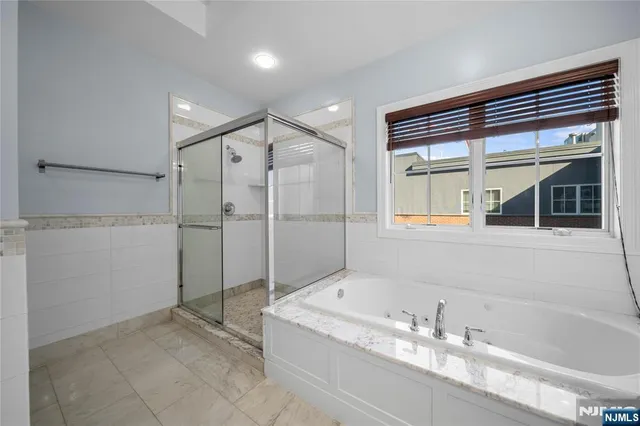 a spacious bathroom with a granite countertop toilet a sink and a mirror