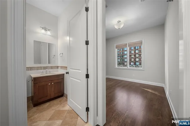 a bathroom with a sink toilet vanity and shower