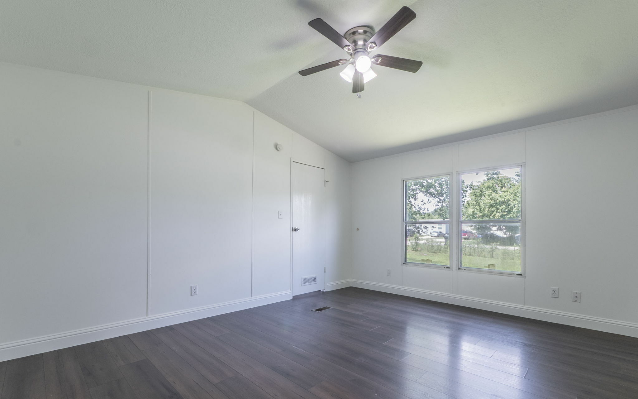178 Quail Ridge Drive Kyle, TX 78640 - Photo 11 of 18 an empty room with wooden floor chandelier fan and windows