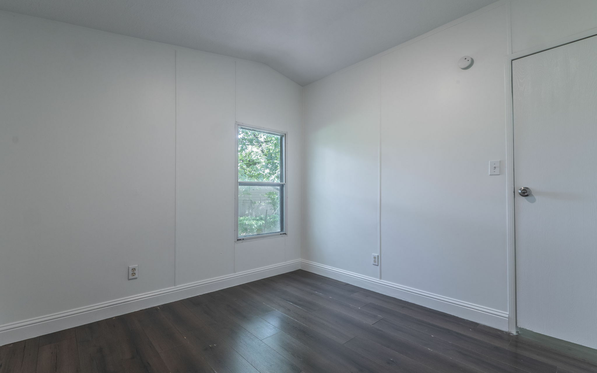 178 Quail Ridge Drive Kyle, TX 78640 - Photo 12 of 18 an empty room with wooden floor and window