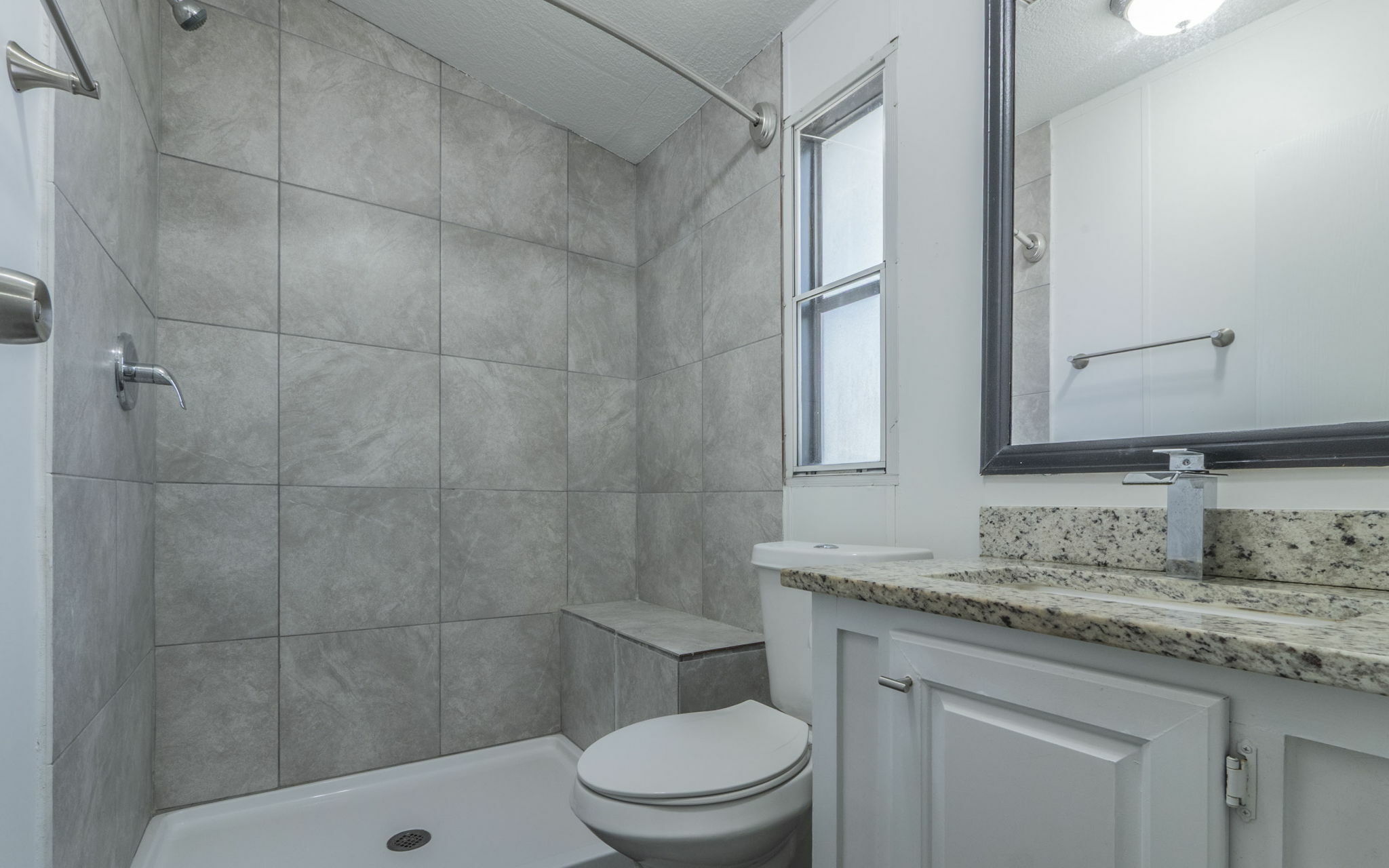 178 Quail Ridge Drive Kyle, TX 78640 - Photo 13 of 18 a bathroom with a granite countertop sink a toilet and shower