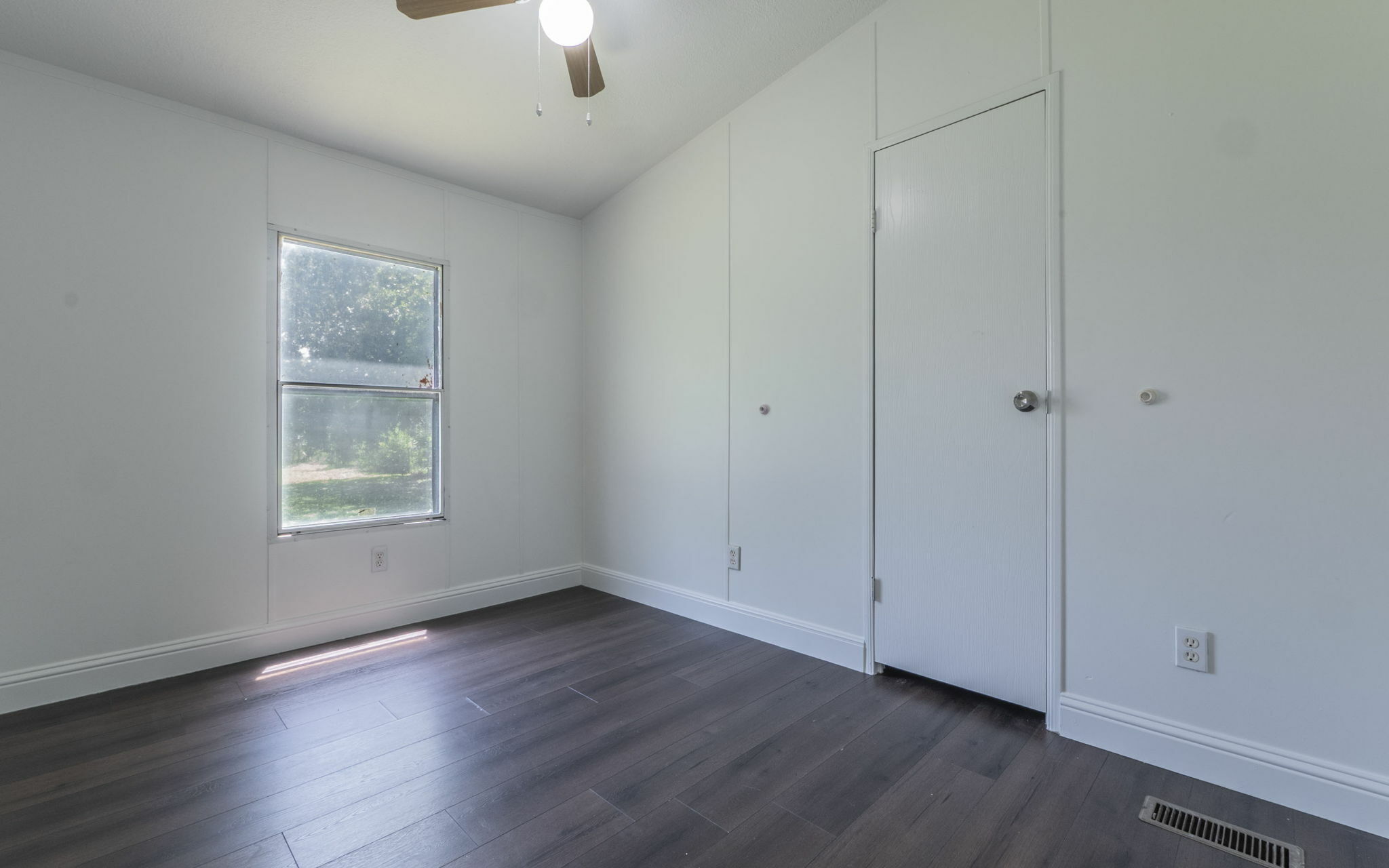 178 Quail Ridge Drive Kyle, TX 78640 - Photo 14 of 18 a view of an empty room with wooden floor and a window