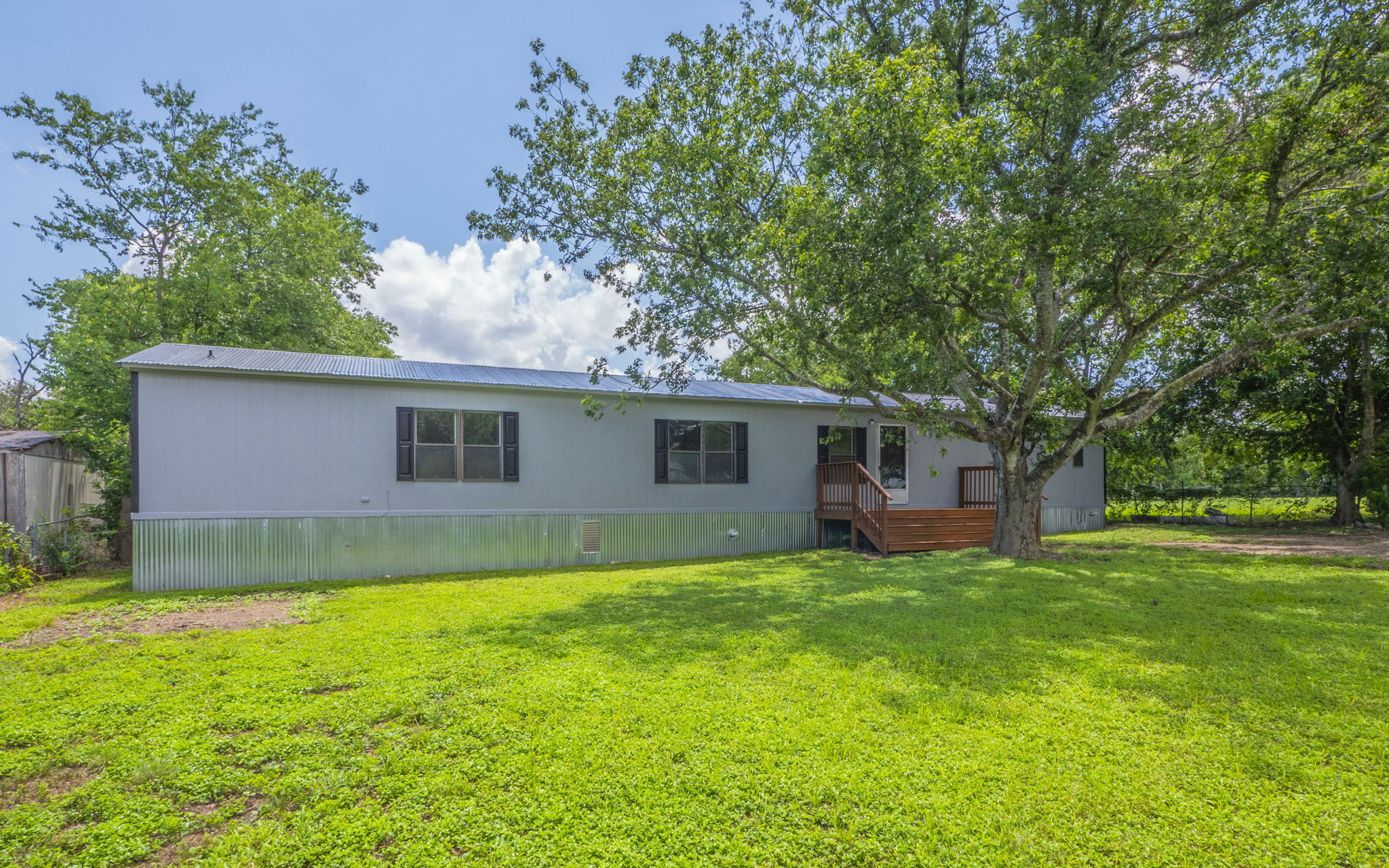 178 Quail Ridge Drive Kyle, TX 78640 - Photo 17 of 18 a view of a yard in front of a house with large trees