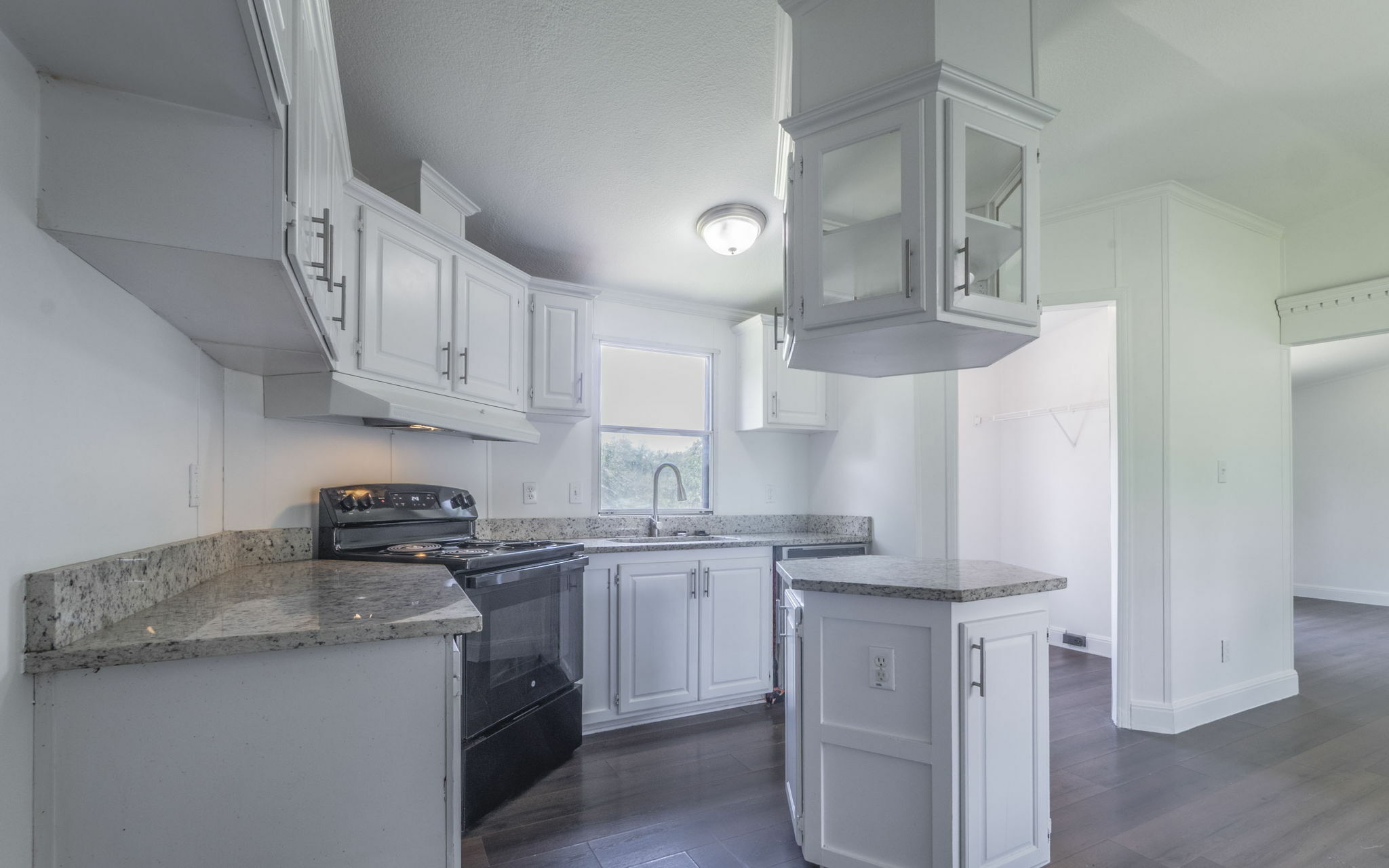 178 Quail Ridge Drive Kyle, TX 78640 - Photo 3 of 18 a kitchen with stainless steel appliances granite countertop a sink a stove a refrigerator and island