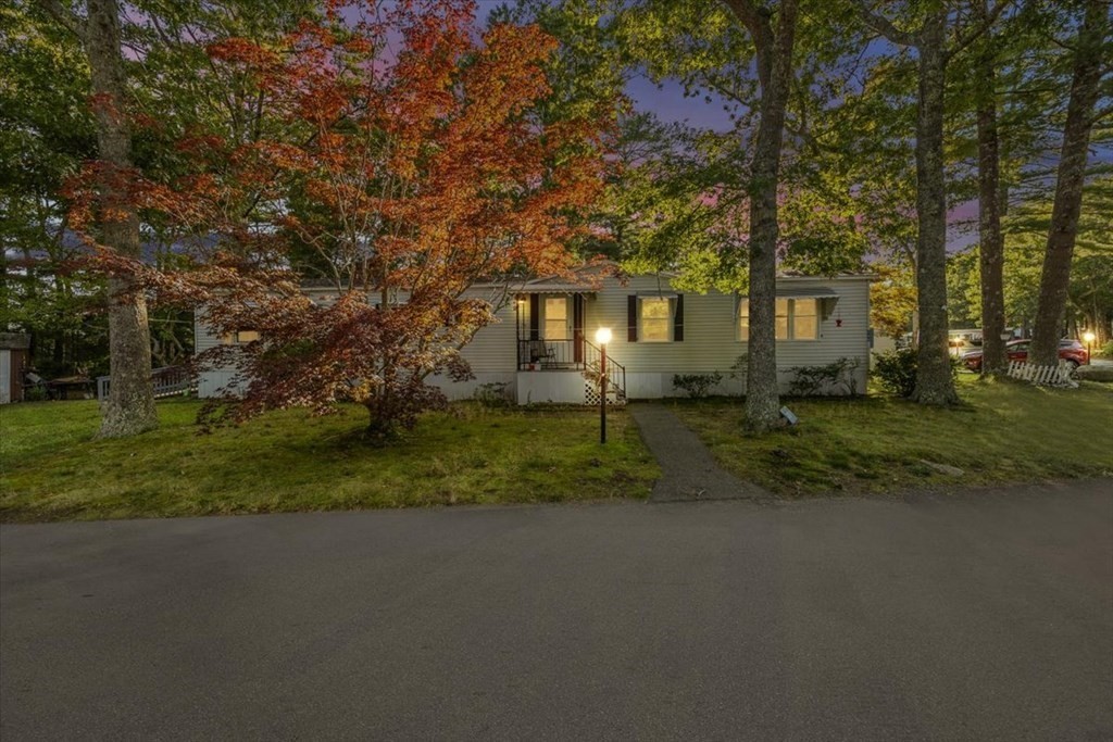 209 Windswept Road Wareham, MA 02571 - Photo 2 of 17 a front view of a house with a yard and trees