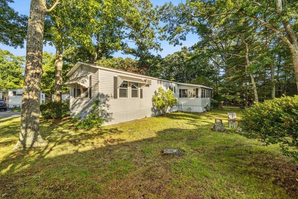 209 Windswept Road Wareham, MA 02571 - Photo 4 of 17 a front view of house with yard and trees around