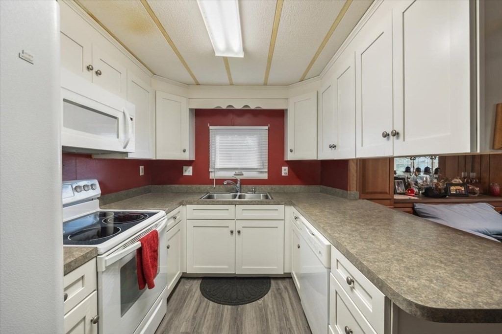 209 Windswept Road Wareham, MA 02571 - Photo 7 of 17 a kitchen that has a sink and a stove in it