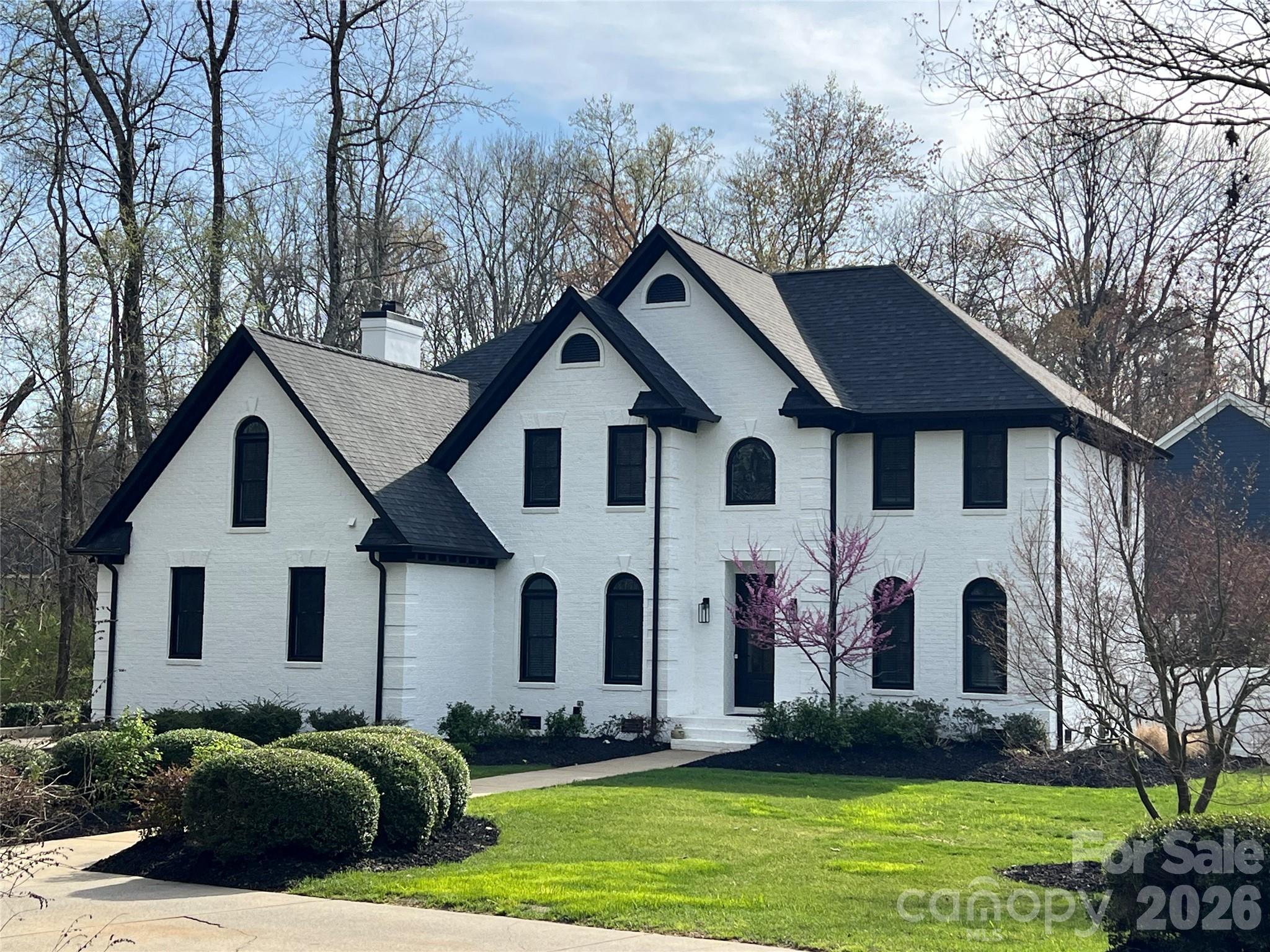 18441 Davidson-Concord Road Davidson, NC 28036 - Photo 1 of 36 a front view of a house with a garden