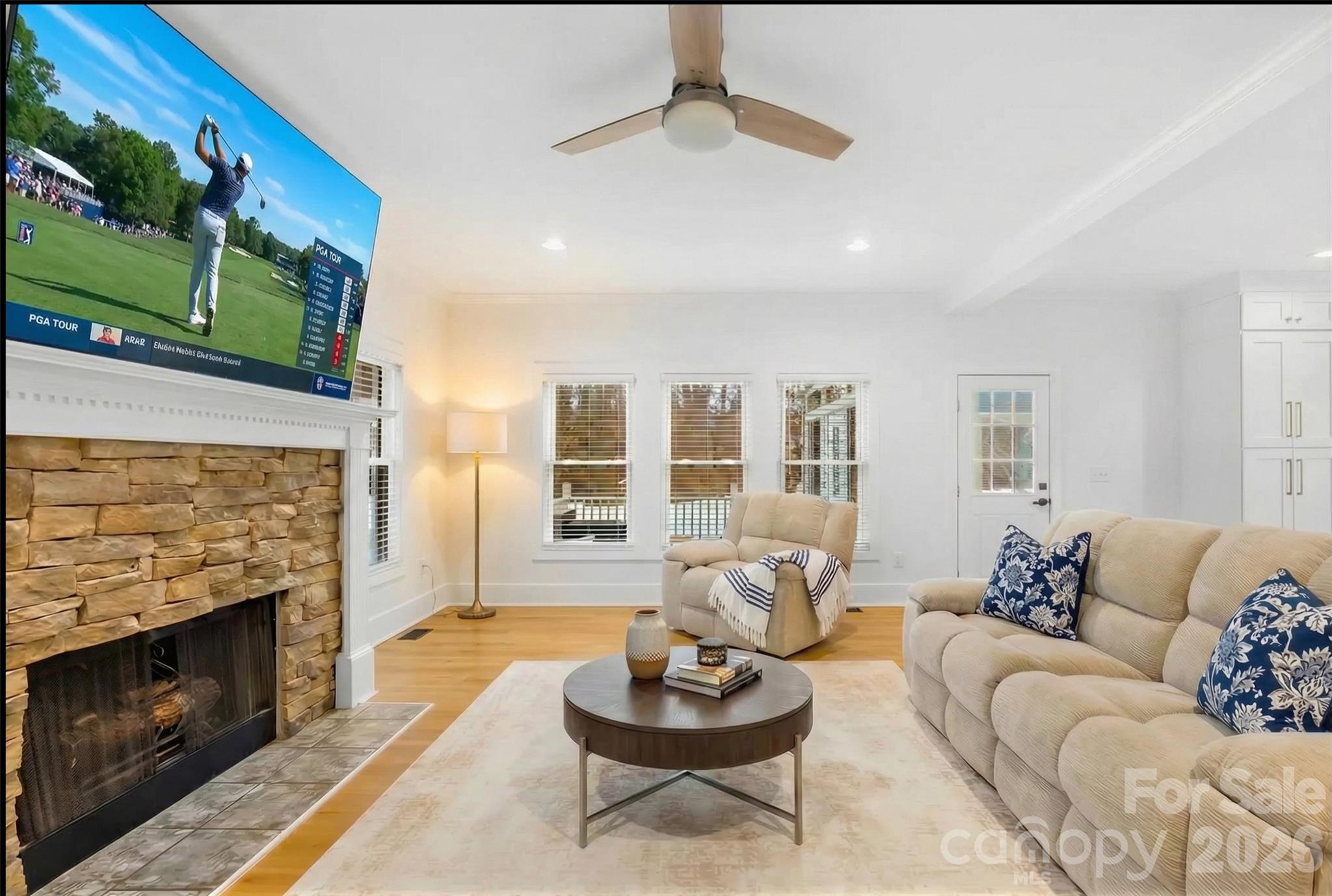 18441 Davidson-Concord Road Davidson, NC 28036 - Photo 13 of 36 a living room with furniture a fireplace and a floor to ceiling window