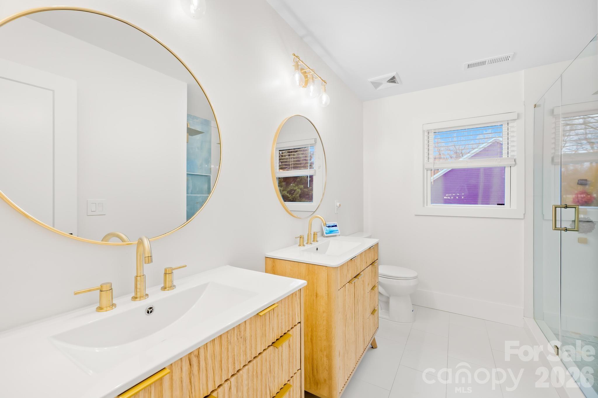18441 Davidson-Concord Road Davidson, NC 28036 - Photo 20 of 36 a bathroom with a sink and a mirror