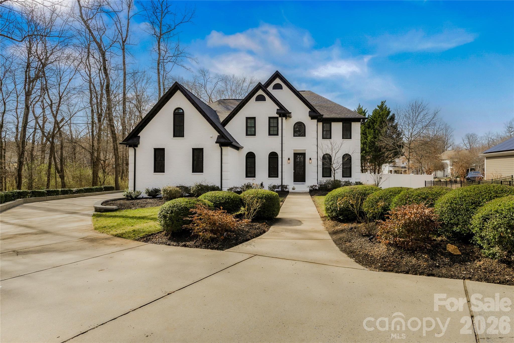 18441 Davidson-Concord Road Davidson, NC 28036 - Photo 2 of 36 a front view of a house with a garden